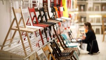 A customer looks at a display of chairs at an IKEA retail store.