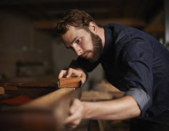 Man sanding a piece of wood